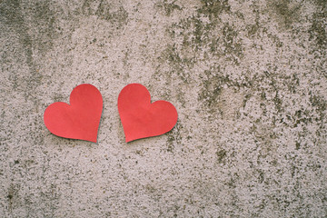 red paper heart shape on concrete background