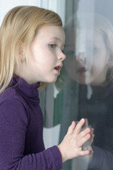 Curious child looking out of the window