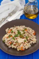 rice with chicken and vegetables on brown plate