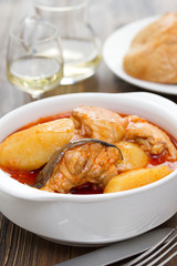 fish stew on white bowl on wooden background