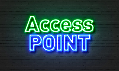 Access point neon sign on brick wall background.