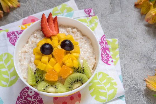 Oatmeal porridge with a chick face decoration