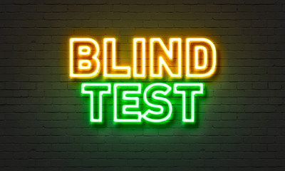 Blind test neon sign on brick wall background. © ibreakstock