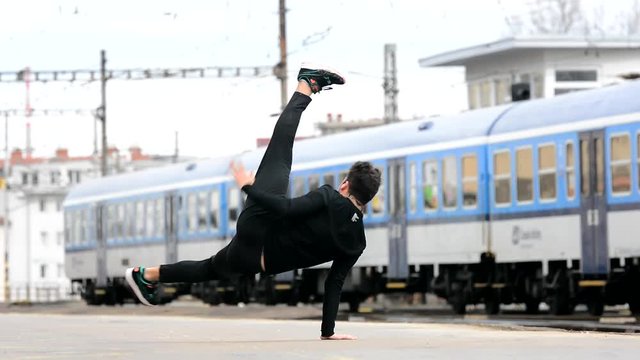 Young man dancing breakdance on the street.