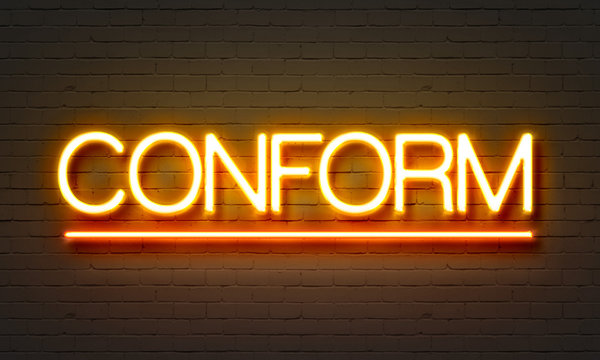 Conform neon sign on brick wall background.