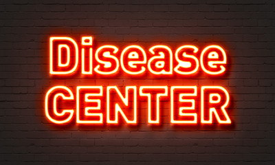 Disease center neon sign on brick wall background.