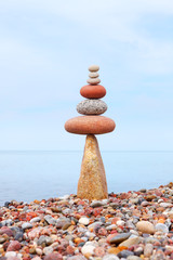 concept of tranquility and balance. Rock zen in the form of a pyramid on the edge of the stone