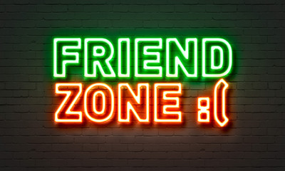 Friend zone neon sign on brick wall background.