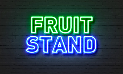 Fruit stand neon sign on brick wall background.