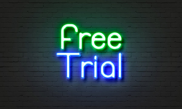Free trial neon sign on brick wall background.