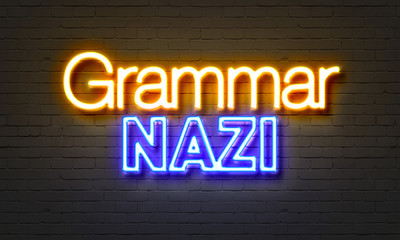 Trammar nazi neon sign on brick wall background.