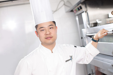 young man chelf in modern kitchen