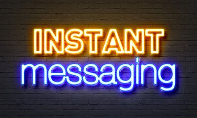 Instant messaging neon sign on brick wall background.