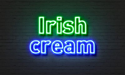 Irish cream neon sign on brick wall background.