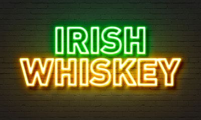 Irish whiskey neon sign on brick wall background.