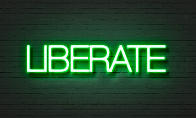 Fototapeta premium Liberate neon sign on brick wall background.
