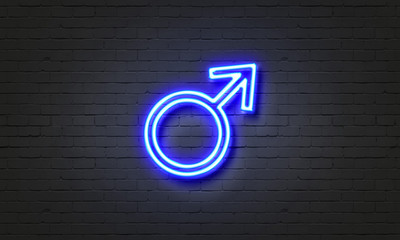 Male symbol neon sign on brick wall background.