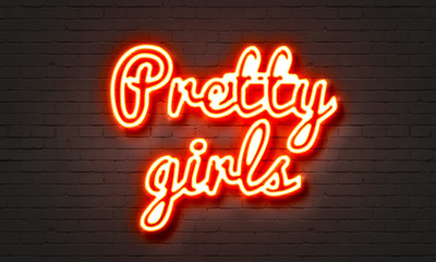 Naklejka na ściany i meble Pretty girls neon sign on brick wall background.