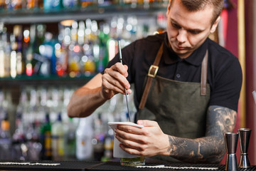 The bartender making cocktail