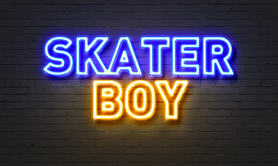 Skater boy neon sign on brick wall background.