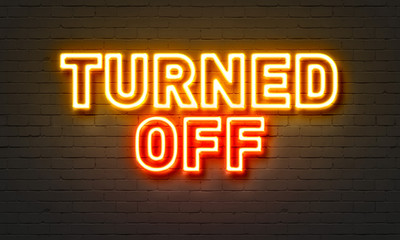 Turned off neon sign on brick wall background.