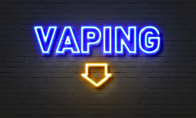 Vaping neon sign on brick wall background.