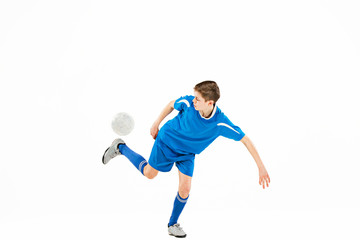 Plakat Young boy with soccer ball doing flying kick