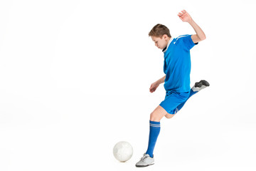 Naklejka na ściany i meble Young boy with soccer ball doing flying kick