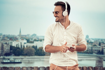 Young man listening to music on a smart phone