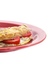 Omelet on a colored plate over white background