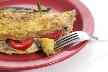 Omelet on a colored plate over white background