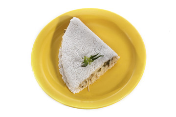 Delicious Tapioca, a brazilian snack made with cassava flour and stuffed with chicken and zucchini on a yellow plate isolated on white background