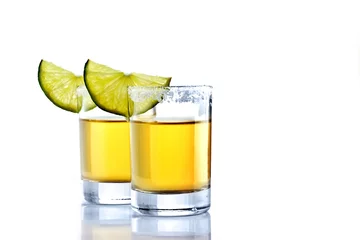  Shot of golden tequila with lime on a white background for isolation © mrzazaz