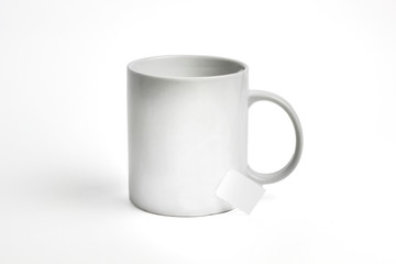 white cup and bag of tea. isolated on white background. Mockup for designs.