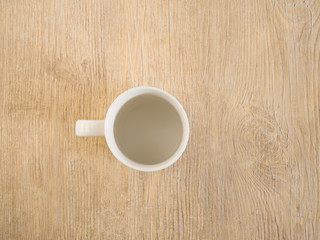 Obraz na płótnie Canvas An isolated empty coffee cup on a wood deck.