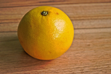 Yellow grapefruit on a wooden table