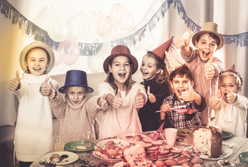 children having celebration of friend’s birthday during dinner