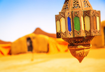 coloreful berber lamp with traditional nomad tents on background