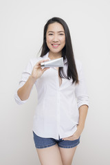 Beauty series: Asian woman holding tube of moisturizer against white background