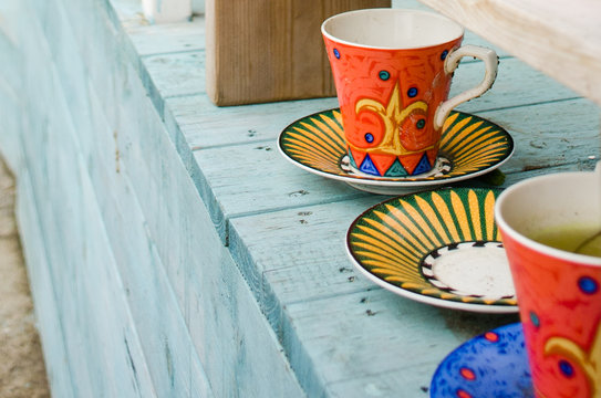 Vivid colored cups and sky blue wooden table give us  comfortable and art inspiration.