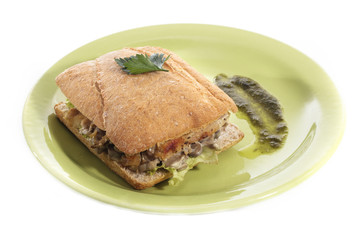 Healthy chicken and mushroom sandwich on green plate over white background