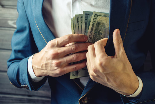Businessman, member or officer puts a bribe in his pocket