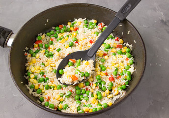 Steamed vegetables with rice in a frying pan.