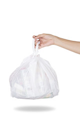 Hand holding white bag of rubbish on white background