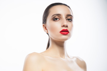 Attractive young female with red lips looking at camera. Horizontal studio shot.