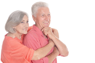 Happy old couple embracing on a white background