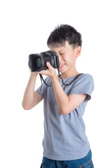 Little asian photographer taking photo over white background