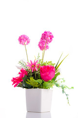 Artificial flower bouquet in ceramic pot over white
