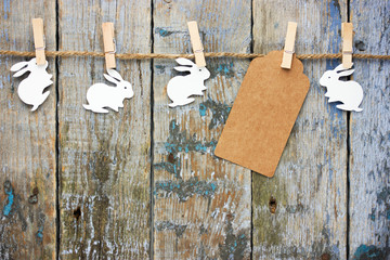 Easter bunny stickers hanging on rustic wooden background