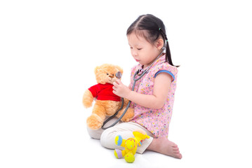 Little asian girl pretend to doctor over white background